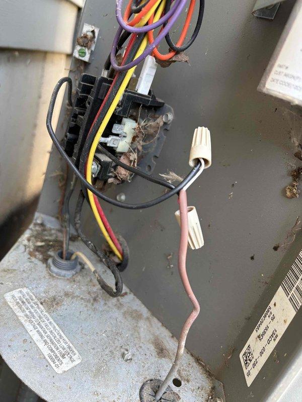 # AC Repair - No Cooling

Responded to service call for 16-year-old Lennox air conditioning system not producing cold air throughout residence. Upon arrival, performed diagnostic inspection of outdoor condensing unit.

Opened electrical compartment and discovered heavy accumulation of organic debris (leaves, twigs, plant material) in bottom of unit housing, indicating prolonged outdoor exposure without adequate maintenance. Removed debris to prevent potential airflow restriction and fire hazard.

Inspected electrical components and identified severe corrosion on contactor relay assembly, showing brown and reddish deterioration patterns consistent with moisture exposure. Corrosion was affecting electrical connectivity and preventing proper compressor operation, which explained complete loss of cooling capacity.

Noted 25/5 MFD dual run capacitor present in system with visible labeling. Evaluated all wire connections including red, yellow, orange, purple, and black conductors. Observed p