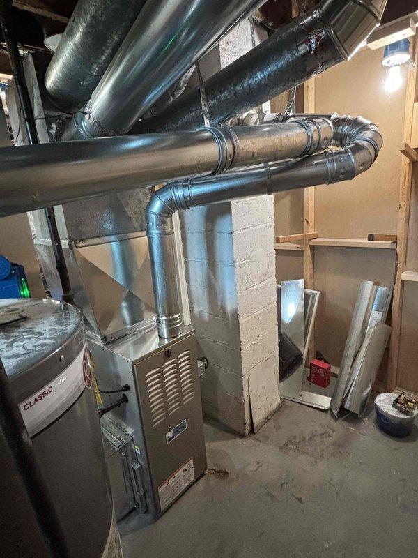 Completed full furnace installation in basement mechanical room. Installed new furnace unit with proper ductwork connections, including metal supply and return ducts with appropriate elbows and joints. Ensured all ductwork properly sealed and secured to unit, verified structural mounting, and confirmed system operational readiness.