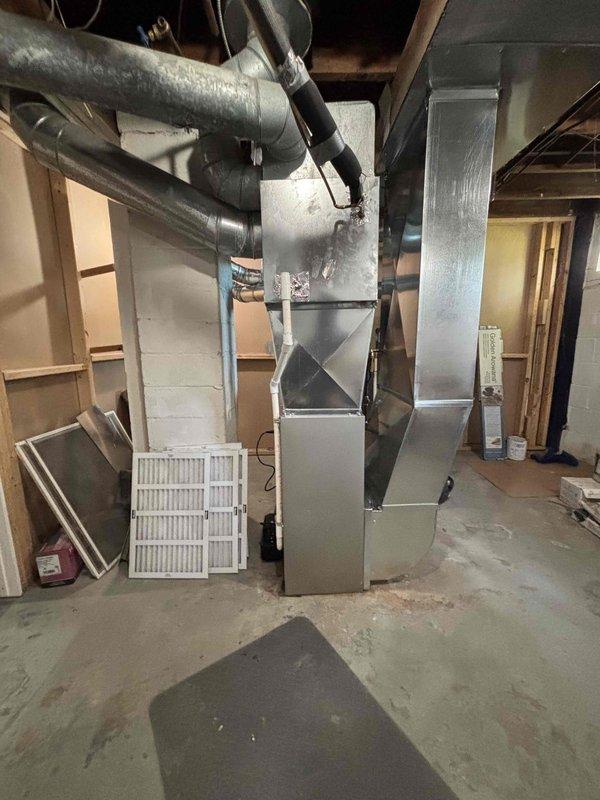 Completed full furnace installation in basement mechanical room. Installed new furnace unit with proper ductwork connections, including metal supply and return ducts with appropriate elbows and joints. Ensured all ductwork properly sealed and secured to unit, verified structural mounting, and confirmed system operational readiness.