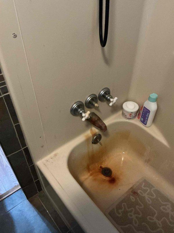 Provided project estimate for sump pump installation in residential property. Additionally assessed bathroom vanity faucet with significant rust corrosion on fixtures and basin, documenting existing plumbing configuration including P-trap assembly and under-sink connections for repair recommendations.