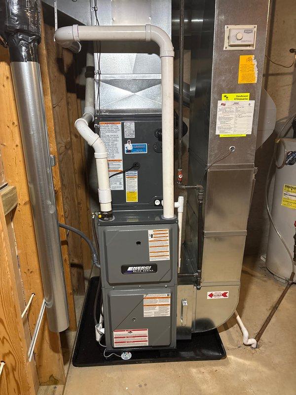 Completed full HVAC system installation including new furnace and air conditioning unit. Installed Amana outdoor condensing unit on concrete pad with proper refrigerant line connections, electrical conduit, and drainage piping. Mounted and connected indoor furnace unit with corresponding air handler, established all necessary PVC venting and condensate drain lines, installed new ductwork connections, and verified proper electrical connections throughout. All equipment tested for proper operation and system commissioned successfully.