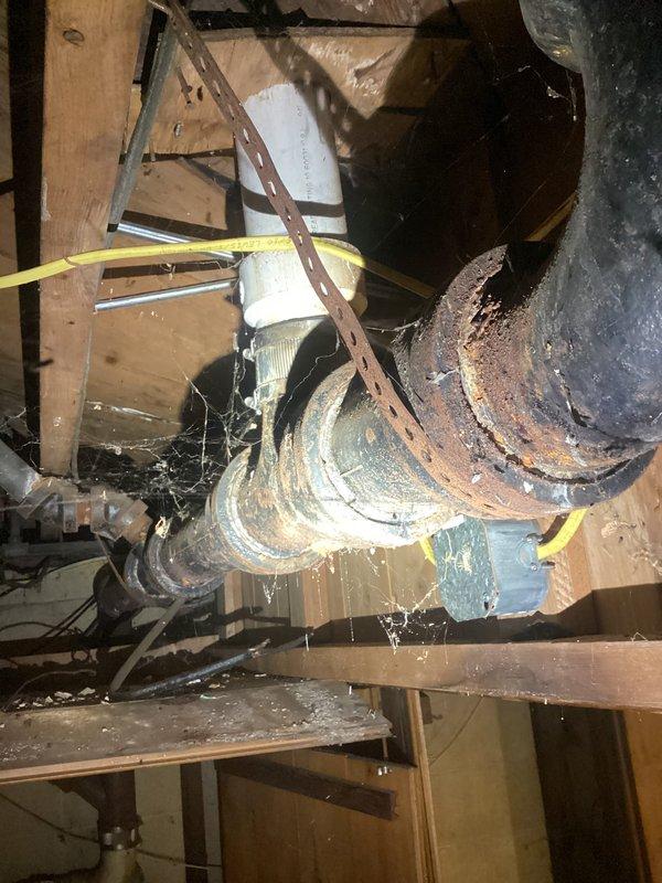 Completed rebuild of bathroom group drain line in crawl space. Removed deteriorated piping and installed new white PVC drain configuration with proper P-trap assembly, secured all connections with metal clamps per code requirements. All work performed in confined space with proper vapor barrier protection maintained throughout installation.