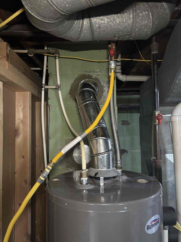 Completed chimney liner installation with proper flashing and weatherproofing at roofline penetration. Installed new stainless steel chimney cap with dome configuration to protect against water intrusion and verified all connections to existing water heater and venting system in mechanical room are secure and functioning properly.
