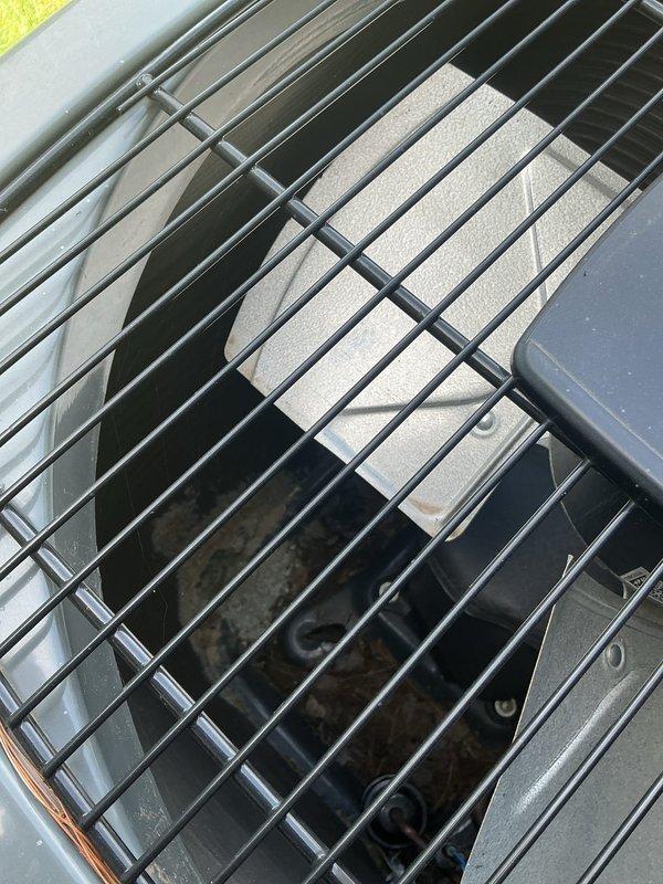 Responded to cooling complaint where system was blowing cool but not cold air affecting entire home. Performed diagnostic evaluation of 2-year-old EnergiAir unit and inspected outdoor condenser assembly, fan operation, and refrigerant lines. Documented equipment condition with photos showing condenser fan guard, internal components, and overall unit status for service records.