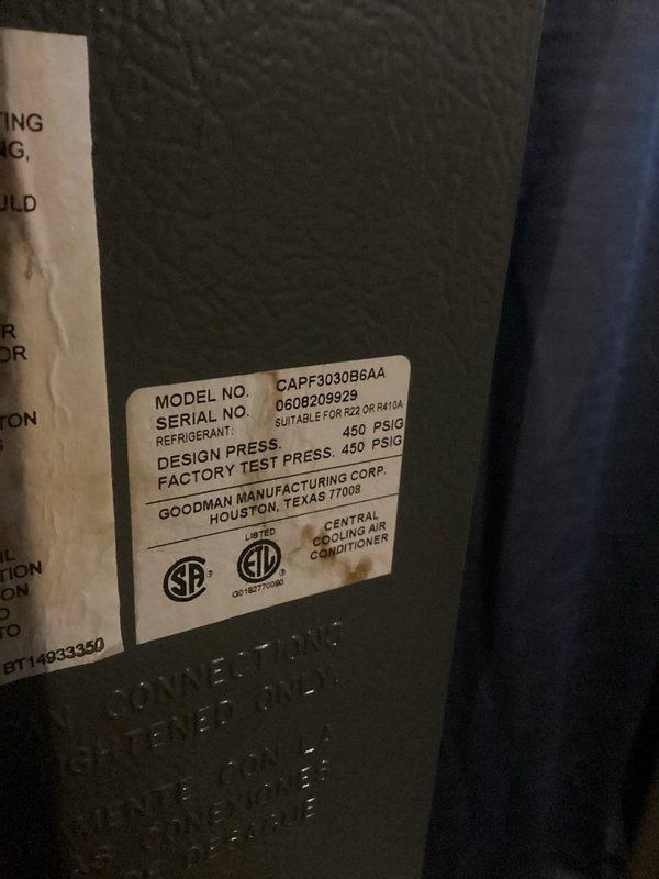 Responded to water leak complaint occurring only during AC operation on 20-year-old Goodman system model CAPF3030B6AA. Upon inspection, identified condensate drainage issue causing water to puddle beneath furnace. Verified evaporator coil drain line and condensate system functionality. Inspected air filter condition, which appeared clean with proper airflow. Documented equipment nameplate information confirming R22/R410A compatible unit manufactured by Goodman Manufacturing Corp. System evaluated and condensate management addressed to resolve leaking condition during cooling mode operation.