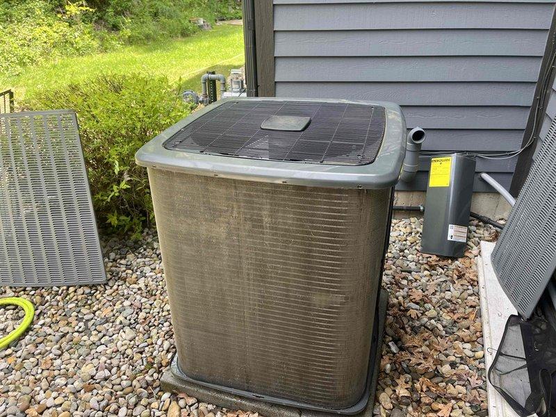 Responded to callback for outdoor unit cleaning concerns following previous maintenance visit. Performed thorough re-cleaning of condenser unit exterior panels, removing accumulated dirt and debris from beige cabinet surfaces. Carefully straightened bent condenser fins using fin comb tool to restore proper airflow and unit efficiency. Verified all sides of unit were properly cleaned, gravel bed maintained, and unit left in satisfactory condition per customer expectations.