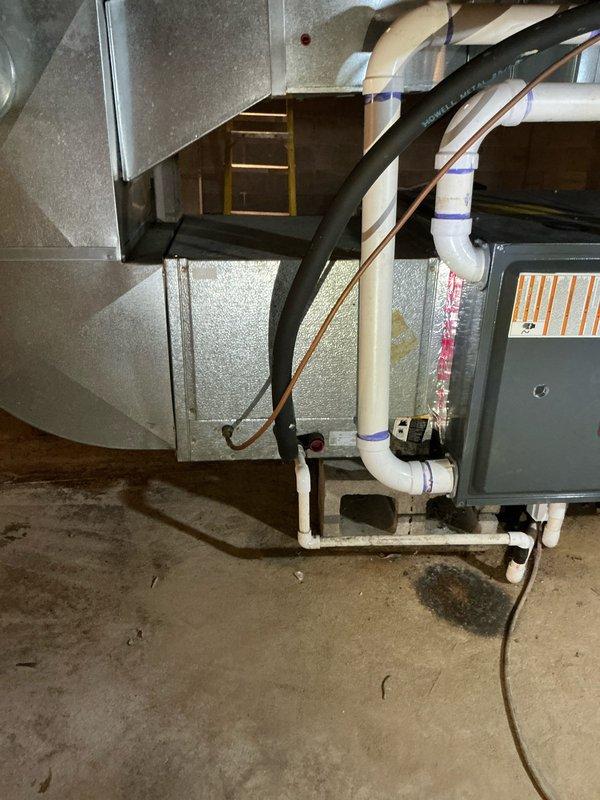 Completed estimate for 25-year-old air conditioning system that has been inoperative since previous cooling season. Performed visual inspection of existing HVAC equipment in basement mechanical room, including furnace unit, ductwork system, and associated components. Documented current system configuration with photographs showing furnace installation, sheet metal plenum and duct connections, refrigerant line routing, condensate drainage, and electrical connections. Assessed overall condition of aging equipment and provided replacement options for non-functional air conditioning system.