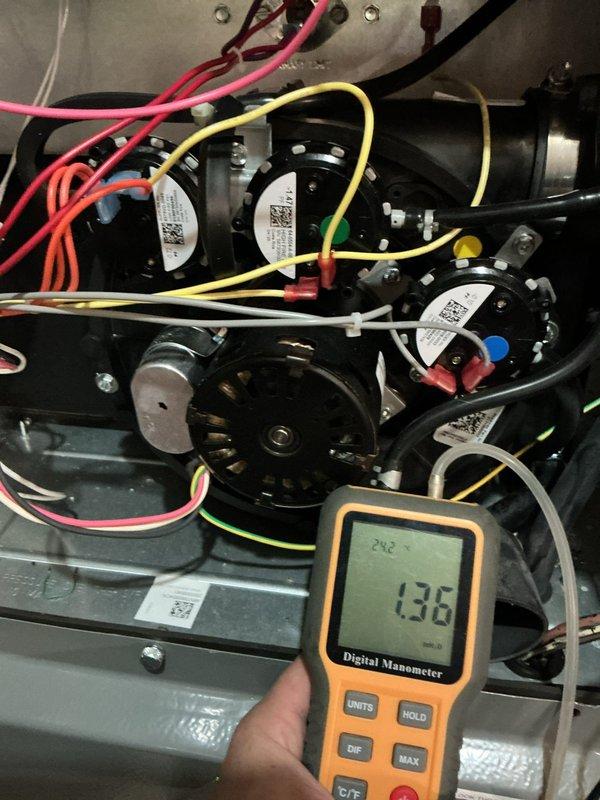 Responded to no heat call on one-year-old EnergiAir furnace. Previous contractor reported unit dropping from high stage to low stage operation due to high stage pressure switch failure and noted venting length exceeded manufacturer specifications. Upon arrival, verified system operation and measured gas pressure at 138" water column using digital manometer. Inspected venting configuration and measured total equivalent length against manufacturer's installation tables. Examined high stage pressure switch operation and electrical connections. Verified all wire terminations, capacitors, and blower motor assembly. Inspected condenser coil cleanliness following previous service visit as requested. Documented system conditions with photos of internal components and venting installation in basement ceiling area. Confirmed proper operation of all safety controls and system staging.