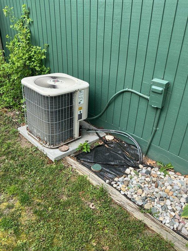 Completed estimate for replacement of 28-year-old furnace and 25-year-old air conditioning system. Existing furnace experiencing gradual failure and outdoor AC condenser unit non-operational. Documented existing equipment including exterior condenser unit positioned on concrete pad with electrical disconnect, and interior furnace showing signs of deterioration with visible structural damage and water staining at installation location.