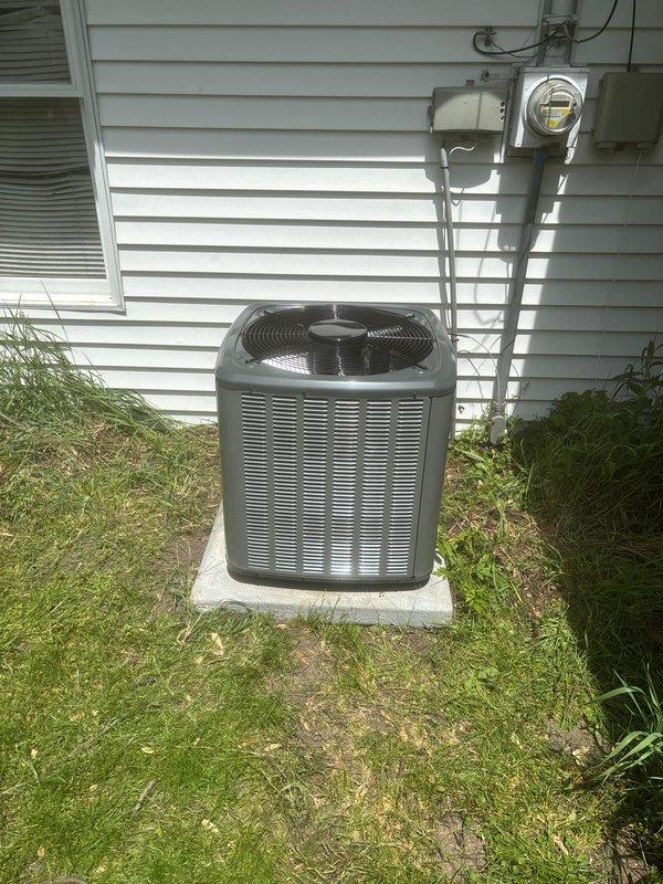 Successfully completed full air conditioning system replacement at residential property. Installed new Lennox furnace unit in basement utility area with comprehensive PVC condensate drain and venting system configuration. Routed copper refrigerant lines from indoor unit to exterior. Positioned new outdoor condenser unit on concrete pad against exterior wall with proper clearances. Installed gray PVC electrical conduit, disconnect box, and completed all electrical connections to meet code requirements. System tested and verified operational upon completion.