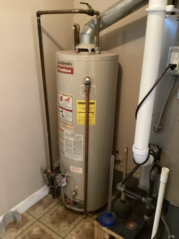 Conducted on-site evaluation of existing A.O. Smith ProMax water heater installation to provide replacement estimate. Documented current system configuration including copper supply and discharge piping, pressure relief valve assembly, and clearance requirements in utility space. Photographed equipment specifications, existing plumbing connections, and surrounding infrastructure to develop comprehensive replacement proposal.