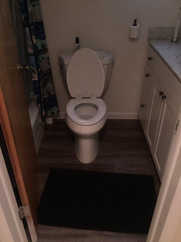 Responded to plumbing leak concern in residential bathroom. Upon inspection, accessed ceiling cavity through attic hatch to investigate potential water intrusion above bathroom area. Examined plumbing fixtures, supply lines, and drain connections for signs of active leaking or moisture damage. Inspected toilet installation, wax ring seal, and water supply connection for proper operation. Verified all visible plumbing components in bathroom were functioning correctly with no active leaks detected at time of service call.