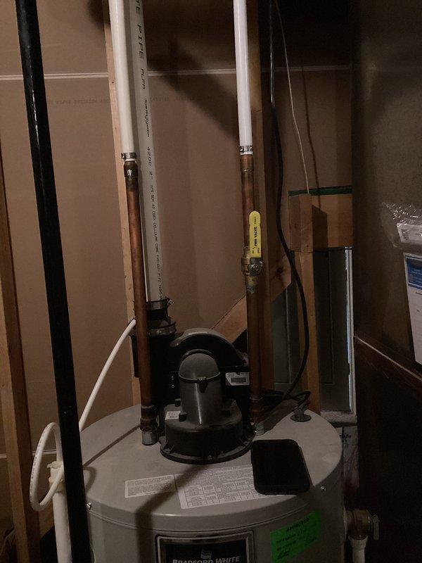 Performed comprehensive assessment of 19-year-old Bradford White water heater for replacement estimate. Evaluated existing plumbing infrastructure including copper supply lines, PVC drainage, main shut-off valve assembly, and mechanical room configuration to provide customer with options for both traditional tank-style and tankless water heater installations.