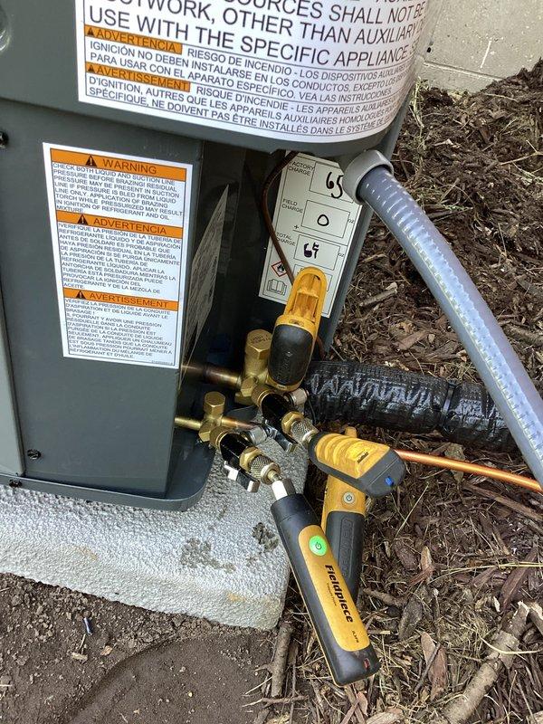Completed full air conditioning system replacement at residential property. Removed existing AC unit and installed new gray condensing unit on concrete pad with proper electrical connections, including meter integration and conduit routing along exterior wall. Connected refrigerant lines with appropriate insulation, installed brass service valves, and performed system testing and commissioning using digital manifold gauges to verify proper refrigerant charge and operating pressures.
