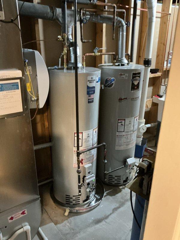 Technician successfully installed a 40-gallon natural gas water heater, tall model, in the mechanical room alongside existing equipment. The installation included proper venting configuration, complete plumbing connections with copper and galvanized piping, shutoff valves, and all necessary fittings per manufacturer specifications and local code requirements.