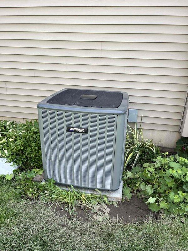 Complete air conditioning system replacement performed at residential property. Removed existing HVAC equipment and installed new Lennox furnace unit in basement utility area with proper venting using white PVC condensate drain lines and ductwork connections including metallic and flexible ducts. Mounted new outdoor condenser unit on concrete pad against exterior wall with proper electrical disconnect box and conduit installation. Verified all manufacturer specifications, completed system startup, and confirmed proper operation of both indoor and outdoor components.