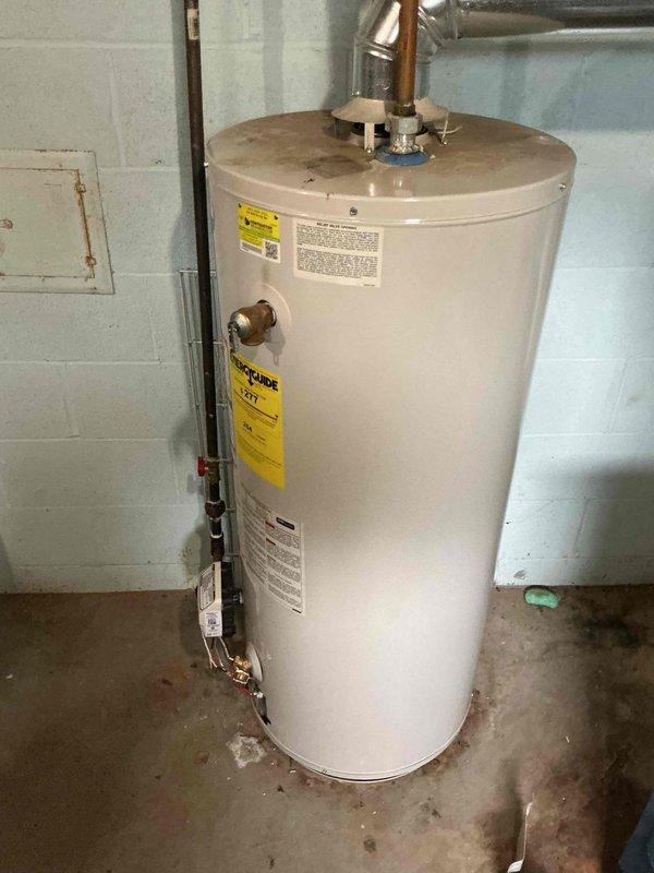 Responded to no-ignition complaint on 15-year-old residential water heater. Customer had previously replaced thermocouple without resolving issue. Confirmed gas supply present and spark generation occurring at pilot assembly. Performed diagnostic testing and determined gas control valve failure preventing proper gas flow to pilot and main burner despite adequate spark and thermocouple function. Recommended water heater replacement due to age of unit and cost-effectiveness compared to repair of failed gas valve on older equipment.