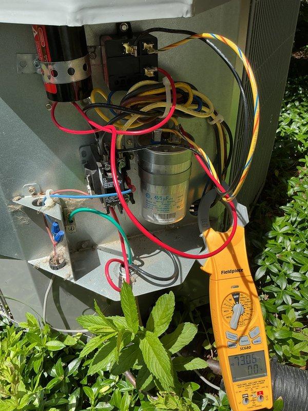 Completed annual cooling maintenance on two outdoor AC units: a 3-year-old Carrier system and a 4-year-old Bryant system. Performed comprehensive tune-up procedures on both units including electrical testing with clamp meter and multimeter, verified capacitor operation and readings, inspected all wire connections and terminals for proper contact and wear, and checked refrigerant pressures. All components tested within normal operating parameters. Both systems operating efficiently with no deficiencies noted.