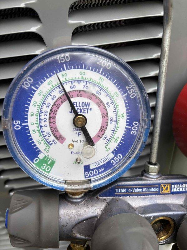 Completed full air conditioning system replacement at residential property. Removed existing AC unit and installed new outdoor condensing unit with proper refrigerant charging and system commissioning. Performed pressure testing using Yellow Jacket 4-valve manifold gauges to verify proper refrigerant pressures across both high and low sides of the system, confirming optimal operating parameters. System tested and verified operational with all readings within manufacturer specifications.
