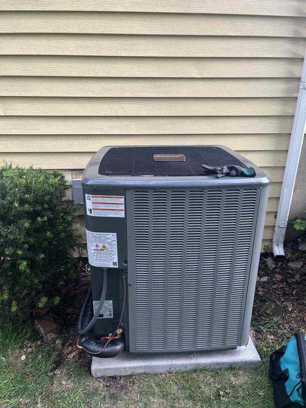 Completed full air conditioning system replacement at residential property. Installed new outdoor condensing unit on existing concrete pad with proper clearances from structure and landscaping, connected refrigerant lines to indoor evaporator coil mounted adjacent to existing furnace system. Verified all electrical connections, tested system operation, and confirmed proper airflow through existing ductwork.
