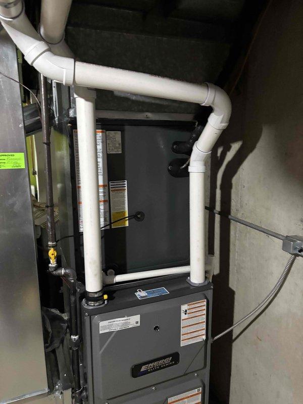 Completed full air conditioning system replacement at residential property. Installed new outdoor condensing unit on existing concrete pad with proper clearances from structure and landscaping, connected refrigerant lines to indoor evaporator coil mounted adjacent to existing furnace system. Verified all electrical connections, tested system operation, and confirmed proper airflow through existing ductwork.