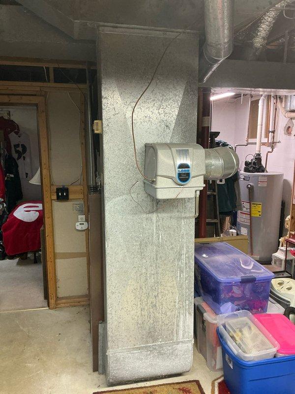 Conducted comprehensive sales estimate for furnace and air conditioning system replacement in residential property. Evaluated existing HVAC equipment location in basement utility area, assessed ductwork configuration including exposed metal ventilation ducts and insulated flexible ducting, and documented current humidifier installation with digital display mounted on structural column. Reviewed space constraints and clearances around existing water heater and plumbing fixtures to determine optimal equipment placement for new furnace and AC system installation.
