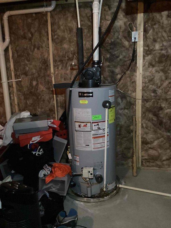 Provided estimate for replacement of existing 9-year-old Lochinvar tank water heater with new tankless water heater system in single-family residential property. Current unit is original to home construction and shows no active failures, leaks, or operational issues. Assessed existing installation including plumbing connections, venting configuration, electrical requirements, and available space in basement utility area to determine scope and feasibility of tankless conversion.
