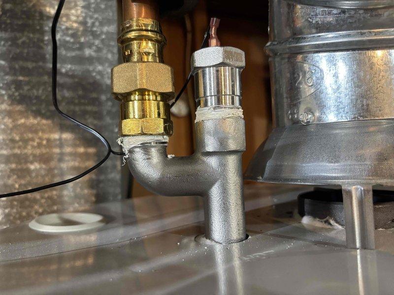 Completed annual cooling system tune-up on 28-year-old International Comfort Products unit with condenser model year 2022. Performed standard maintenance inspection, documented mechanical connections and plumbing components with photographic evidence, and verified all systems operating within normal parameters.
