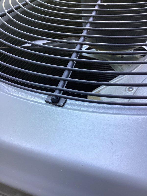 Completed annual cooling maintenance on 14-year-old York air conditioning system. Performed comprehensive tune-up including inspection of exterior condenser unit fan assembly, verified proper airflow through protective grille, and examined outdoor unit condition. All components found operating within normal parameters with routine exterior dust accumulation noted on condenser housing and grille consistent with outdoor exposure.