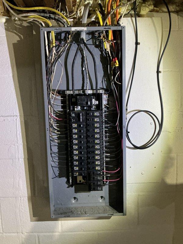 Responded to service call for non-functioning electrical outlets and switches. Performed comprehensive electrical club inspection of the property's electrical systems. Inspected main breaker panel, verifying proper circuit breaker operation, wire connections, and overall panel integrity. Examined exterior electrical components including conduit, junction boxes, and connections near HVAC equipment. Documented panel configuration showing dual-row breaker arrangement with multiple circuits serving the residence. All findings photographed for service records.