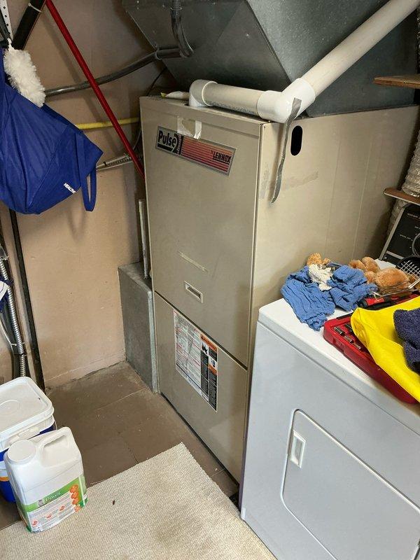 Completed estimate for air conditioning system at residential property. Documented existing HVAC equipment including Lennox Pulse furnace with PVC venting and metal cabinet air handler unit in basement utility area. Photographed current system configuration and equipment conditions to provide accurate assessment for AC replacement or upgrade options.