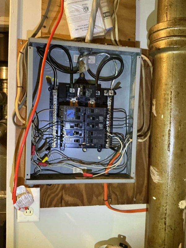 Responded to inquiry regarding bathroom exhaust fan wiring and installation. Conducted site assessment and documented existing electrical panel configuration in utility area. Panel inspection revealed multiple circuit breakers with various wire gauges including orange and red cables, adjacent to vertical metallic ductwork and ventilation components in unfinished utility space. Advised client that exhaust fan installation and wiring falls outside current service scope and recommended referral to qualified electrician for proper evaluation and installation work.