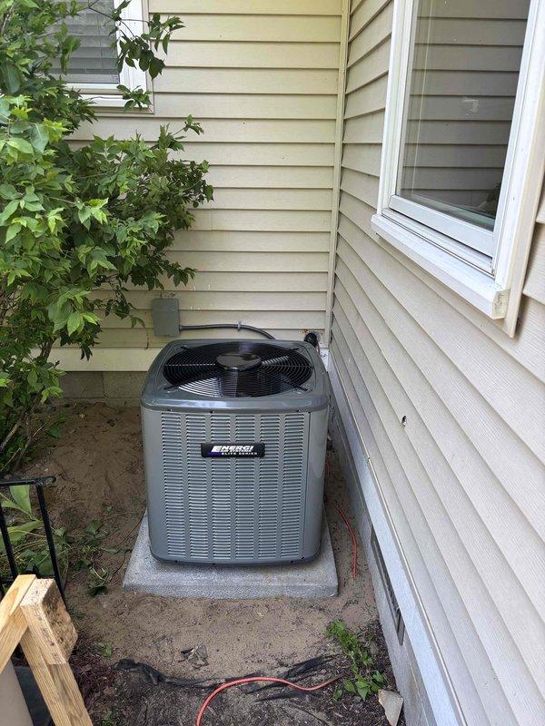 Completed full air conditioning system installation at residential property. Installed new outdoor condenser unit on concrete pad in side yard, positioned between house and fence with proper clearance for airflow and serviceability. Connected electrical service via conduit and disconnect box mounted to exterior wall, ensuring code-compliant wiring and proper grounding. Unit commissioned and tested for proper operation, refrigerant charge verified, and all safety controls confirmed functional.