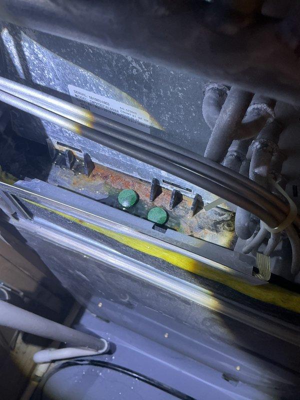 Completed annual cooling maintenance on Carrier air conditioning system per 6-year maintenance agreement. Performed comprehensive system inspection including condenser unit evaluation, electrical connections check, and interior component assessment. Observed moderate to significant corrosion and rust on interior metal surfaces and housing components, particularly around connection points and equipment framework. Noted foam insulation sections present on refrigerant lines. Inspected wiring and electrical connections, including yellow-striped cable routing. Documented equipment condition with photographs showing weathered components, dust accumulation, and oxidation throughout accessible areas. Verified condenser unit exterior condition and heat exchanger fin integrity. System operational at time of departure.