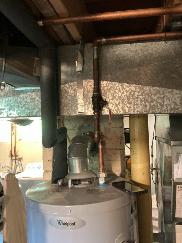 Responded to service call for Whirlpool water heater not producing hot water. Upon inspection, evaluated unit connections, gas supply line, copper piping, and overall system operation in basement utility area. Diagnosed issue, performed necessary repairs to restore hot water production, and verified proper function of water heater with no visible leaks detected at time of service.