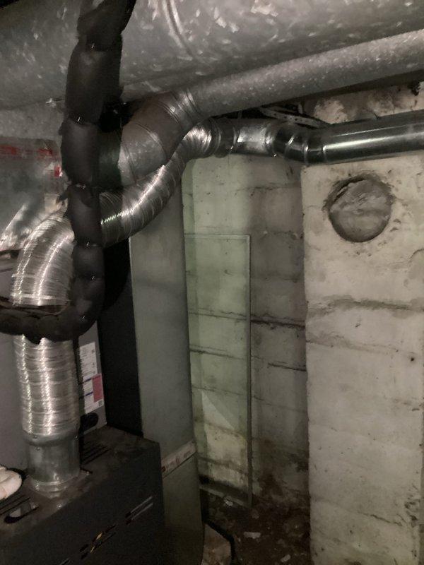 Responded to service call regarding HVAC system safety assessment related to damaged chimney ventilation. Conducted inspection of basement mechanical systems and documented existing ductwork configuration, confirming that heating and cooling equipment was previously vented through compromised chimney structure. Provided written confirmation that operating furnace or air conditioning system without proper ventilation poses safety hazard and is not recommended until alternative venting solution is installed. Photographed HVAC infrastructure including flexible aluminum ductwork, mechanical connections, and basement utility area to support documentation for insurance claim purposes.