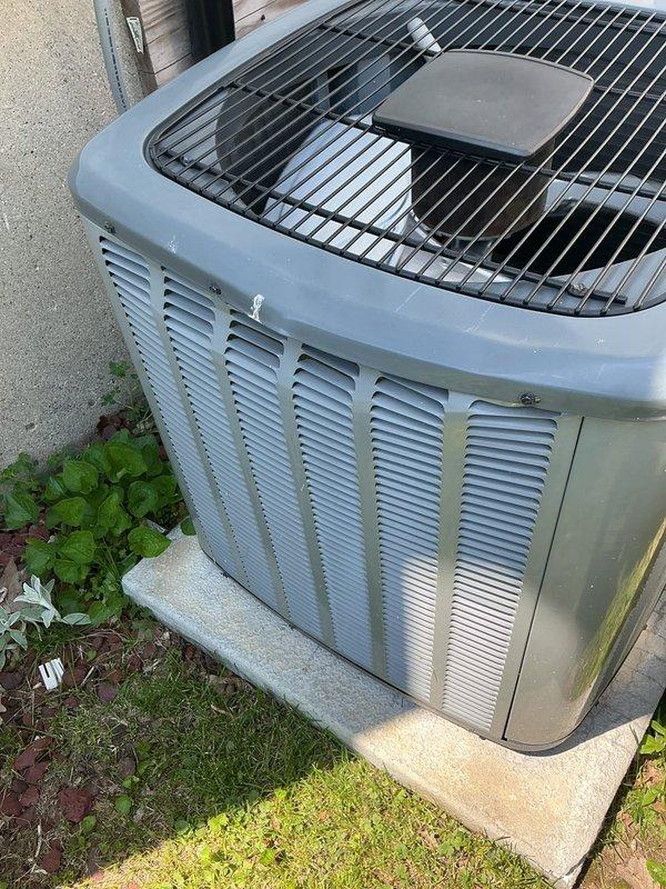 Completed routine annual cooling maintenance on a six-year-old EnergiAir central air conditioning system for Comfort Club member. Performed comprehensive AC tune-up including inspection of condenser unit, verified proper operation of all components, and documented unit condition with photographs. Unit exterior showed normal weathering with some algae discoloration on casing but all mechanical systems functioning within normal parameters.