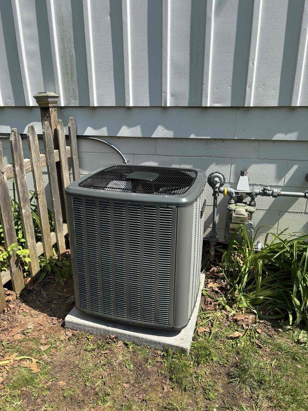 Completed add-on air conditioning system installation to existing forced-air heating system. Installed outdoor condensing unit on concrete pad with proper clearances from building exterior and electrical disconnect. Ran refrigerant lines from outdoor unit through building envelope to basement mechanical room. Integrated evaporator coil with existing furnace and connected to supply ductwork. Installed necessary electrical connections, tested system operation, and verified proper airflow and refrigerant charge levels.