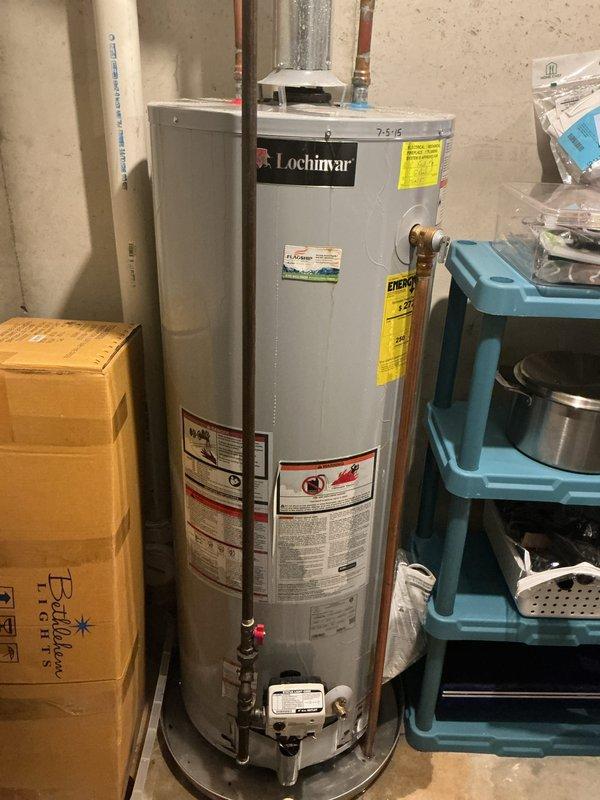 Responded to no hot water call affecting entire residence. Upon arrival, inspected 6-year-old Lochinvar gas water heater in basement utility area. Diagnosed faulty gas control valve preventing burner ignition. Photographed equipment and surrounding plumbing infrastructure including copper supply lines, PVC venting system, and galvanized ductwork for documentation purposes. Verified gas supply, electrical connections, and proper venting configuration. Unit operational following repair with full hot water restoration confirmed throughout home.