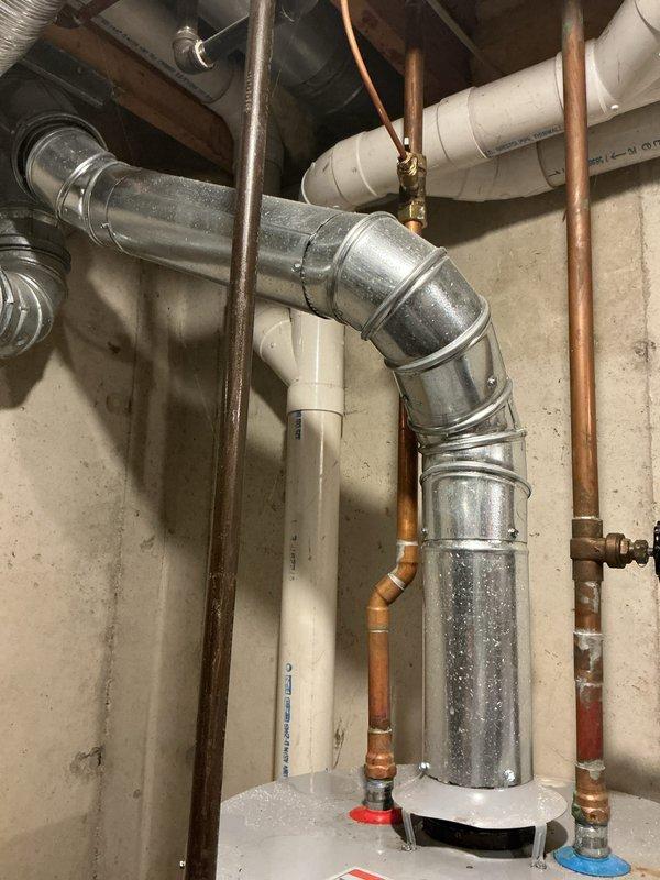 Responded to no hot water call affecting entire residence. Upon arrival, inspected 6-year-old Lochinvar gas water heater in basement utility area. Diagnosed faulty gas control valve preventing burner ignition. Photographed equipment and surrounding plumbing infrastructure including copper supply lines, PVC venting system, and galvanized ductwork for documentation purposes. Verified gas supply, electrical connections, and proper venting configuration. Unit operational following repair with full hot water restoration confirmed throughout home.