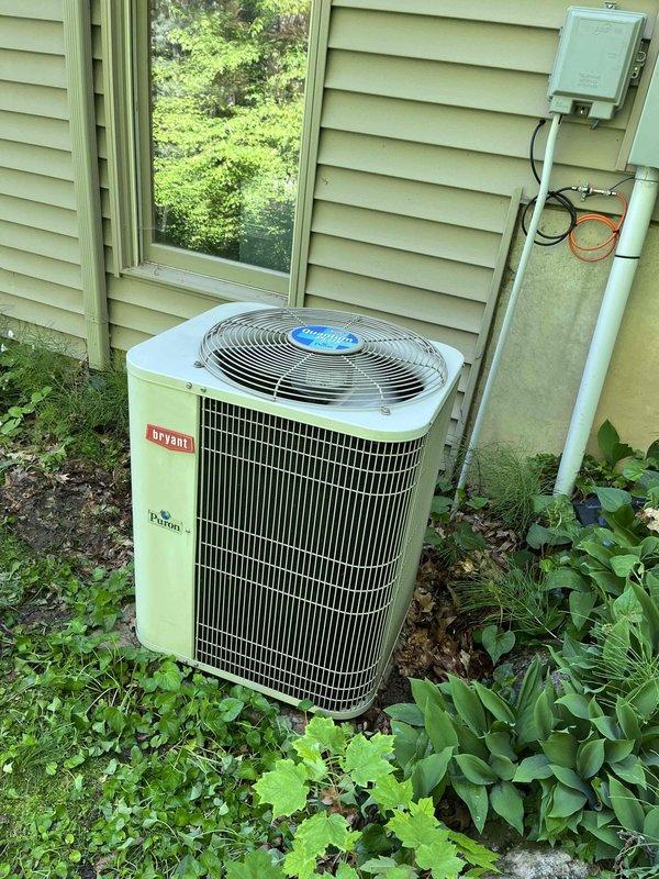 Completed annual cooling maintenance on 20-year-old Bryant outdoor condensing unit. Removed accumulated leaves and organic debris from electrical compartment that had collected around contactor, capacitor, and low-voltage wiring. Inspected all electrical connections, contactor operation, and dual-run capacitor condition. Cleaned condenser coil, verified proper refrigerant pressures, and confirmed unit operational parameters within manufacturer specifications.