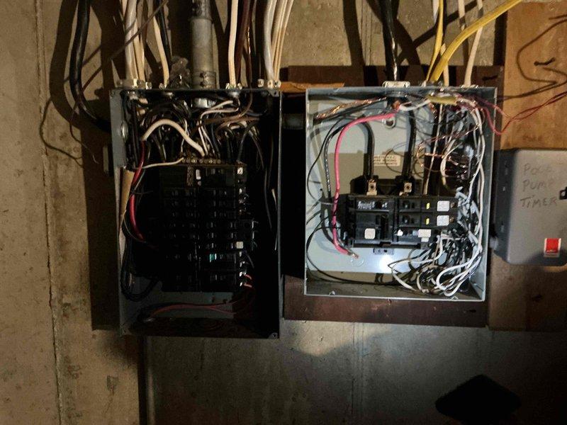 Completed comprehensive electrical club inspection of dual-panel electrical system. Documented existing conditions including circuit breaker configurations, wire routing from both panels, and overall installation integrity. Photographed open panels revealing multiple circuits with black, white, red, and yellow conductors, verifying proper connections and identifying areas requiring attention for code compliance and safety standards.