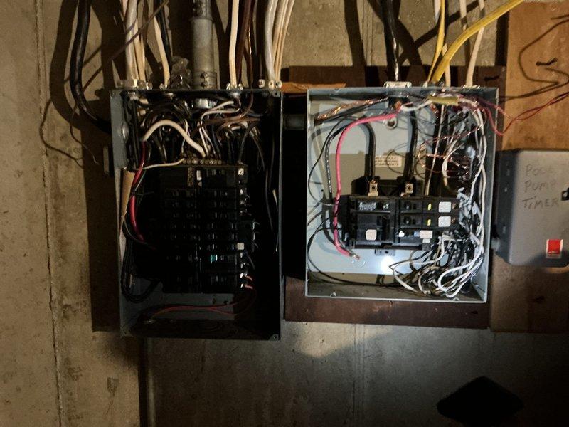 Completed comprehensive electrical club inspection of dual-panel electrical system. Documented existing conditions including circuit breaker configurations, wire routing from both panels, and overall installation integrity. Photographed open panels revealing multiple circuits with black, white, red, and yellow conductors, verifying proper connections and identifying areas requiring attention for code compliance and safety standards.