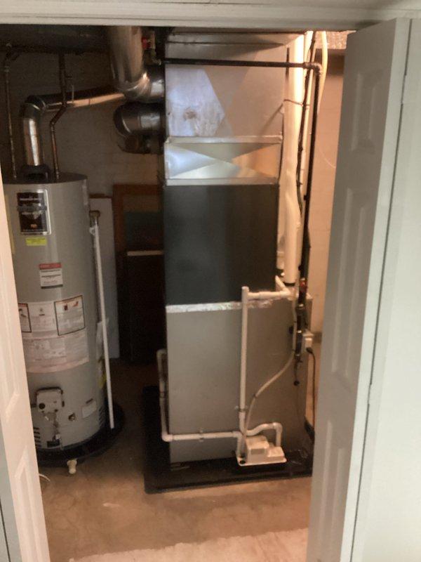 Completed full air conditioning system installation at residential property. Installed new outdoor condenser unit on existing concrete pad with proper clearances from structure and positioned for optimal airflow. Connected refrigerant lines and electrical service to condenser. Inside mechanical room, installed or connected indoor air handler unit with associated drainage piping and verified proper integration with existing furnace system. Tested system operation, confirmed proper refrigerant charge, verified electrical connections, and ensured all components functioning within manufacturer specifications.