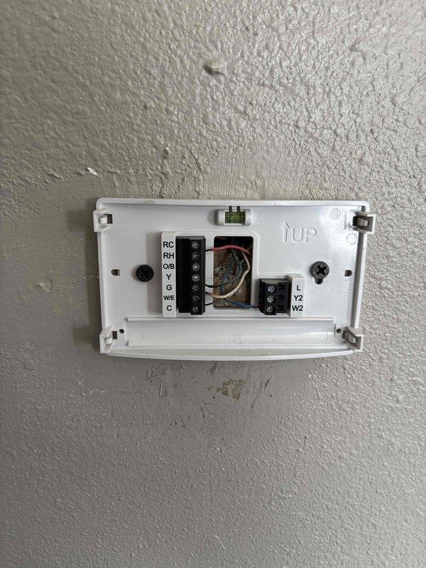 Responded to no cooling call on Carrier system. Upon arrival, confirmed outdoor unit and indoor blower were not operating when thermostat was set to cooling mode. Inspected thermostat wiring and found improper connections at terminal block. Corrected thermostat wire terminations per manufacturer specifications. Verified proper 24V control voltage present at thermostat. Cycled system through cooling mode and confirmed outdoor unit and indoor blower now operating properly. System restored to normal cooling operation.