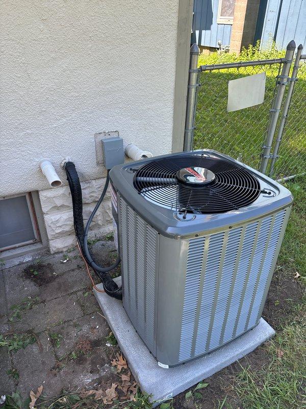 Completed full air conditioning system replacement including outdoor condenser unit installed on concrete pad with proper refrigerant line connections and condensate drainage via white PVC piping. Indoor installation included Goodman furnace with integrated air handler, vertical condensate drain line, and all necessary ductwork connections. System was properly commissioned, tested for operational efficiency, and all components verified for proper function with financing documentation processed through electronic signature platform.