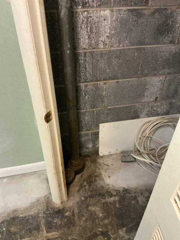 Responded to pre-purchase home inspection findings for two plumbing leaks in vacant residential property. Addressed leak under kitchen sink that was penetrating through to basement level, causing visible water damage, staining, and moisture infiltration on basement walls and floor surfaces. Inspected and addressed secondary leak under bathroom sink contained within vanity cabinet. Documented extensive moisture damage in basement area including wall discoloration, efflorescence on concrete block surfaces, and deterioration around vertical plumbing stack. Evaluated pipe conditions and leak sources at both fixture locations to prevent further water intrusion prior to occupancy.