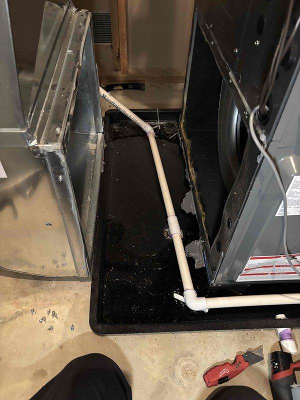 # NC-No Cool Service Completion

Responded to no cooling/heating call on HVAC system in recently purchased home. Upon arrival, found standing water in condensate drain pan beneath air handler, indicating drainage system failure. Inspected both furnace and air conditioning units, which were completely non-operational. 

Diagnosed primary issue as clogged condensate drain line causing safety float switch activation, shutting down entire system to prevent water damage. Cleared obstruction from PVC condensate drain piping using appropriate tools. Verified proper drainage flow and confirmed water was evacuating from drain pan correctly.

Performed electrical inspection of both heating and cooling systems. Checked all wire connections, control board functionality, and safety switches. Reset float switch after confirming drain line was flowing freely. Tested thermostat communication with equipment.

Cycled system through heating and cooling modes to verify full restoration of operation. Confi