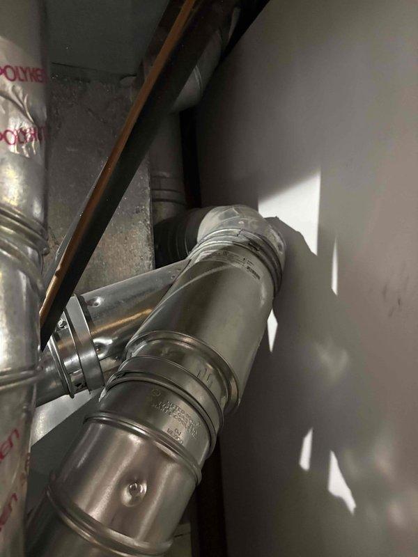 Responded to no hot water complaint on 15-year-old Bradford White water heater. Upon inspection, evaluated existing water heater installation including copper supply lines, brass shut-off valves, and venting system in utility space. Documented equipment condition through photographs showing aged copper piping with oxidation, multiple shut-off valves with red handles, and metallic flex duct venting configuration. Assessed water heater and associated plumbing infrastructure to determine system failure and provided estimate for water heater replacement due to unit age and loss of hot water production.