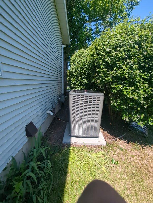 Completed full HVAC system installation including new furnace and air conditioning unit. Interior furnace unit installed in basement utility area with proper electrical connections, ductwork integration, and plenum assembly. Exterior condensing unit positioned on concrete pad along side of house with refrigerant lines and electrical conduit properly routed and connected. All components tested and operational upon completion of installation.